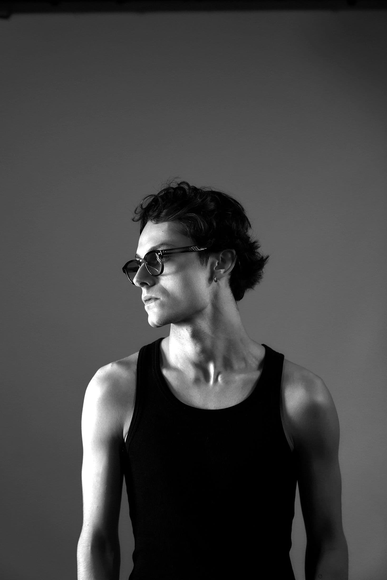 Portrait of ONEYED wearing sunglasses and a black tank top