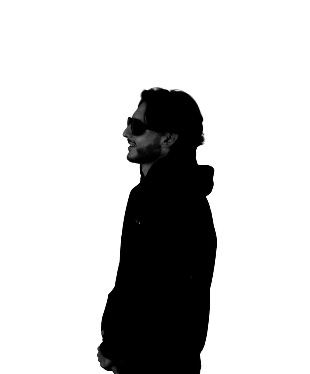 Paolo Parras in profile, wearing sunglasses and a black hoodie