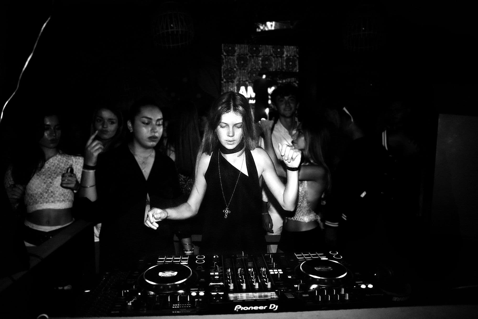 MYKANA playing on CDJs in a dark club