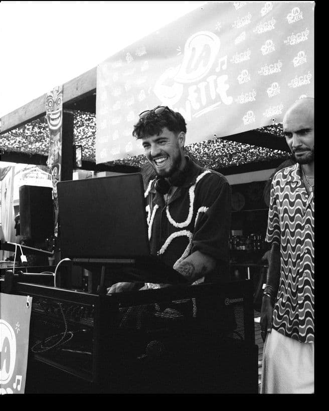 SMAILO laughing at the DJ booth during an outdoor event